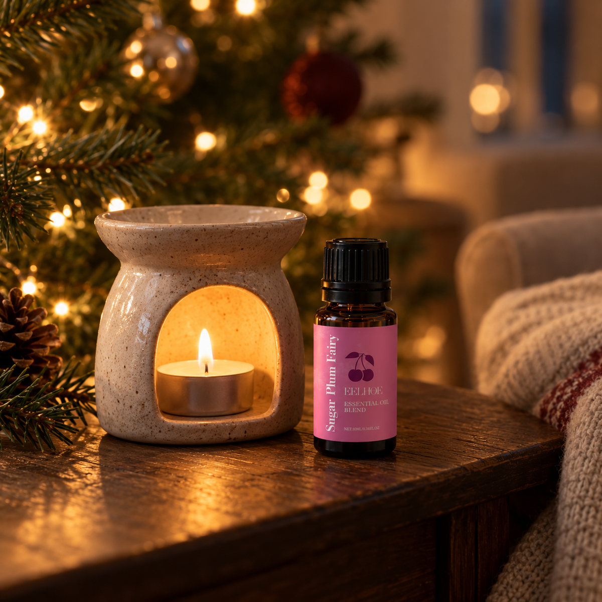 Holiday fragrance oil bottles on a table with a candle