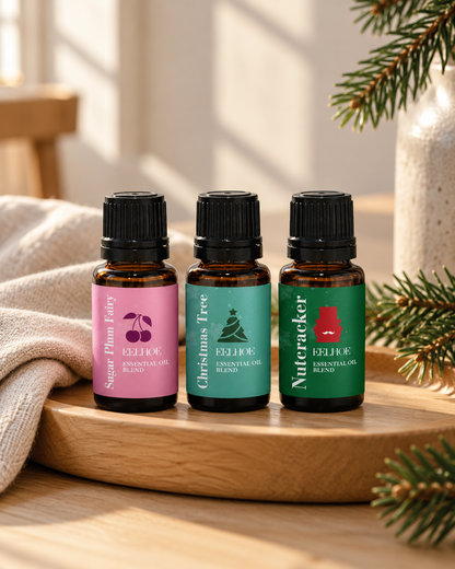 Three holiday fragrance oil bottles in a Christmas setting