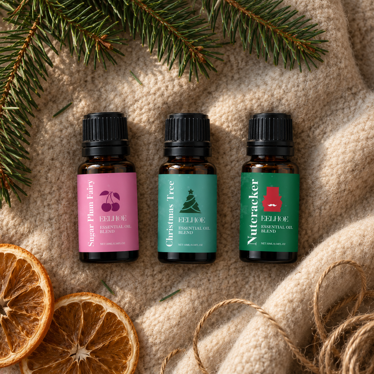 Three holiday fragrance oil bottles on a wool blanket